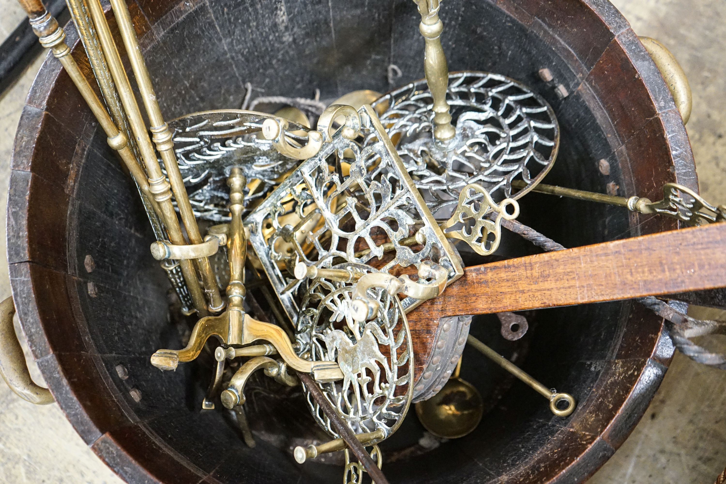 A copper bound staved oak log bin, sundry trivets and fire irons, width over handles 62cm